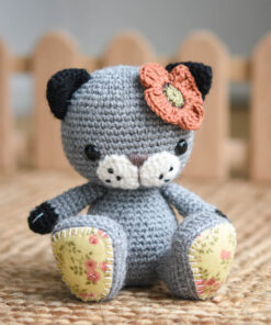 Crochet cat with a poppy