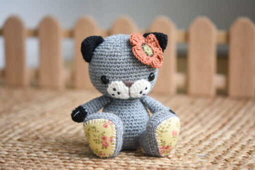 Crochet cat with a poppy