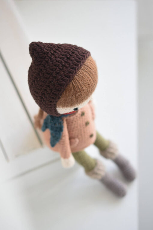 Crochet doll in a coat and bonnet